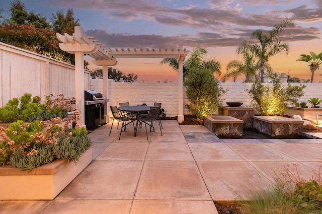 view of patio / terrace featuring area for grilling, outdoor dining space, a pergola, and a fenced backyard