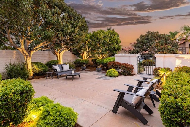 view of patio / terrace with a gate, outdoor lounge area, and fence