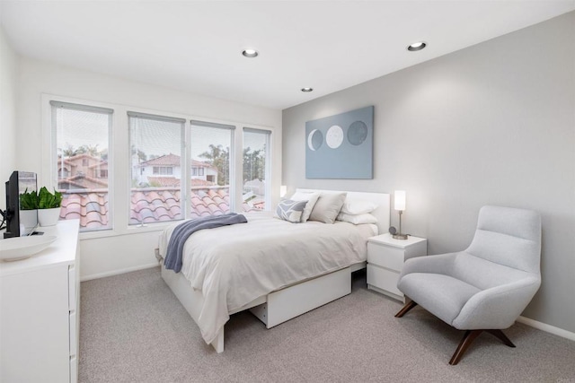 bedroom with recessed lighting, baseboards, and light carpet