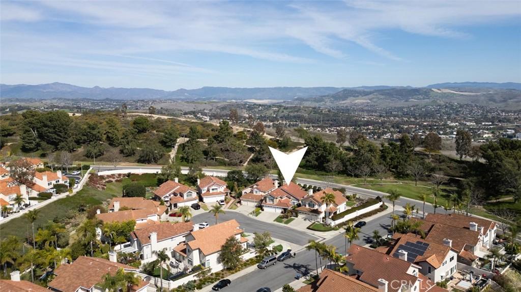 8 Belle Isle Dr, Laguna Niguel, CA 92677 - aerial overview of property's location with a mountainous background and nearby suburban area