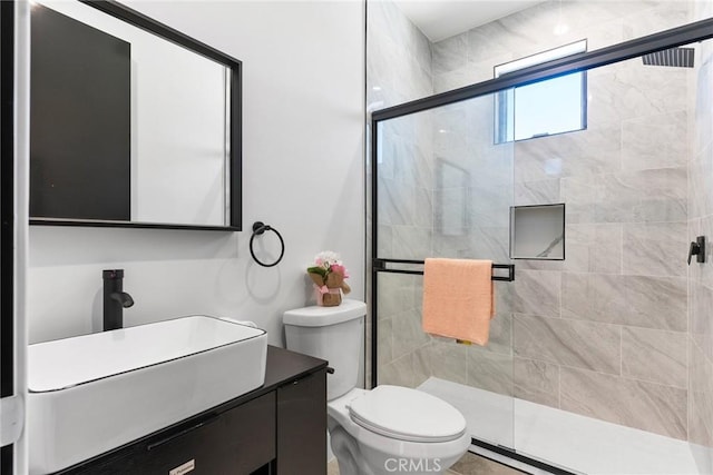 full bath with a shower stall, toilet, and vanity