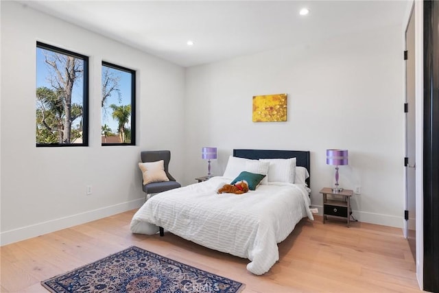 bedroom with light wood-style flooring, recessed lighting, and baseboards