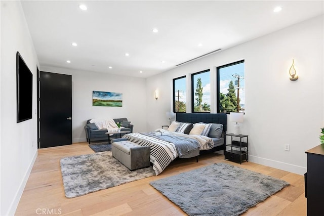 bedroom with recessed lighting, light wood-style flooring, and baseboards