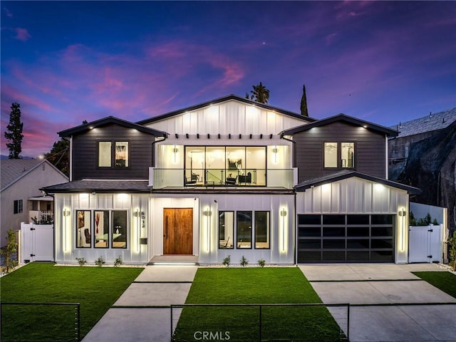 modern farmhouse featuring a balcony, a gate, fence, and board and batten siding