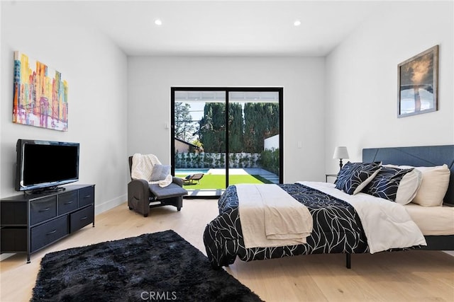 bedroom with access to exterior, recessed lighting, and light wood-style flooring