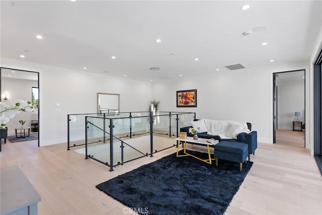 interior space with light wood-style floors, recessed lighting, visible vents, and baseboards