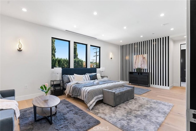 bedroom with recessed lighting, light wood-style floors, and baseboards