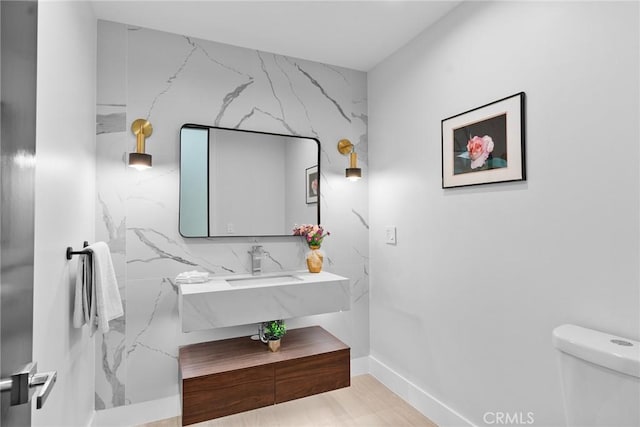 bathroom featuring toilet and a sink