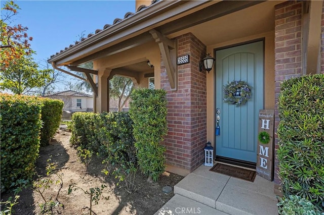 entrance to property with brick siding