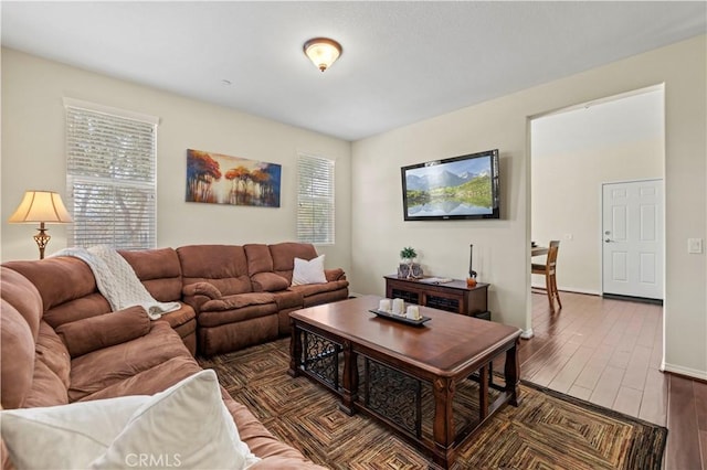 living area with wood finished floors and baseboards