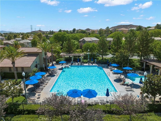 pool with a patio, fence, and a pergola