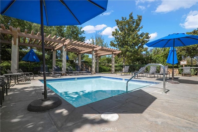 pool with a patio area and a pergola