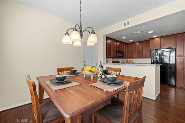 dining area featuring baseboards, visible vents, dark wood finished floors, recessed lighting, and a chandelier