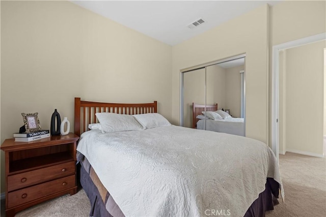 bedroom featuring light colored carpet, visible vents, a closet, and baseboards