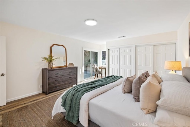 bedroom featuring visible vents, access to outside, wood finished floors, and baseboards