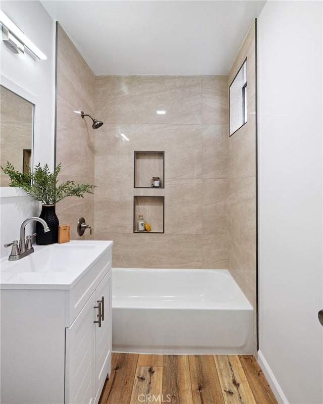 full bath with vanity, bathing tub / shower combination, and wood finished floors