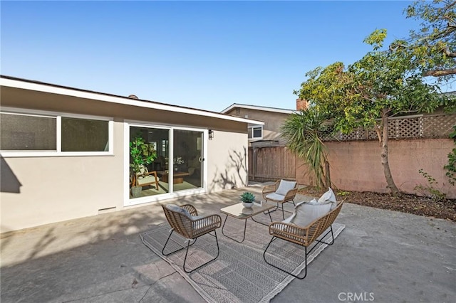 view of patio with fence and an outdoor hangout area