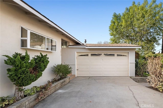 garage with concrete driveway