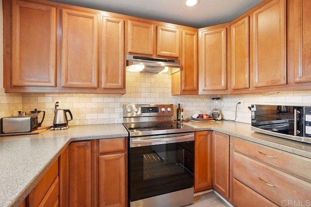 358 Mainsail Rd, Oceanside, CA 92054 - kitchen with stainless steel electric range, under cabinet range hood, tasteful backsplash, and recessed lighting