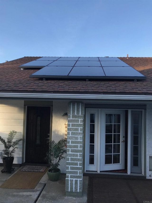358 Mainsail Rd, Oceanside, CA 92054 - entrance to property with a shingled roof, roof mounted solar panels, and stucco siding