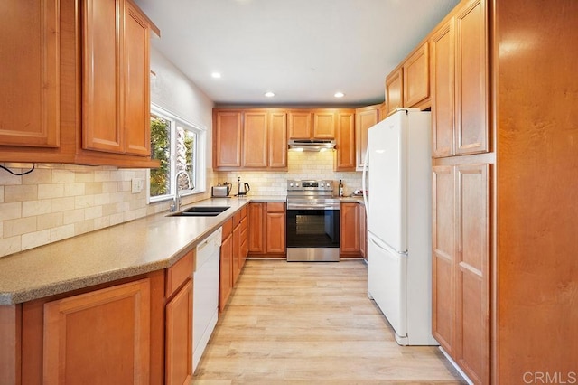358 Mainsail Rd, Oceanside, CA 92054 - kitchen with white appliances, under cabinet range hood, light wood finished floors, tasteful backsplash, and light countertops