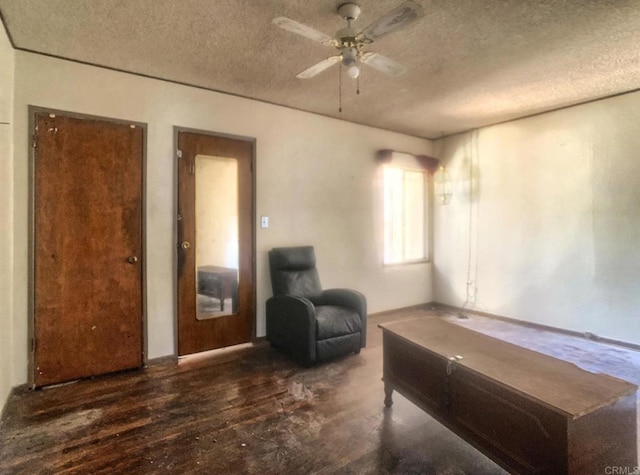 sitting room with a textured ceiling, ceiling fan, and wood finished floors