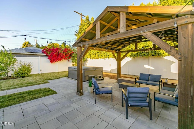 view of patio featuring outdoor lounge area, a gazebo, a fenced backyard, and a hot tub