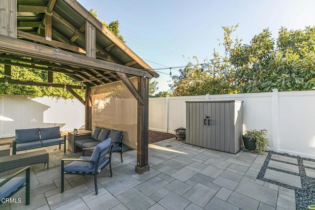 view of patio with an outdoor living space and a fenced backyard