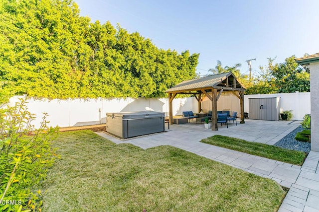 view of yard featuring a gazebo, a hot tub, a fenced backyard, and a patio area