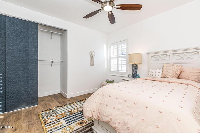 bedroom with ceiling fan, baseboards, and wood finished floors