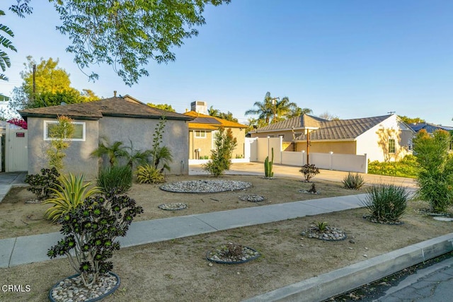 view of front of property with fence and stucco siding