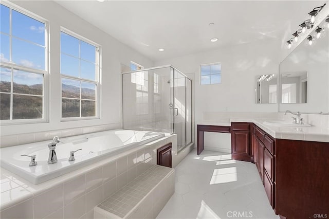 bathroom featuring a stall shower, recessed lighting, a bath, and vanity