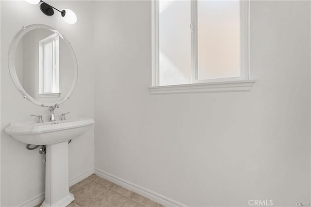 bathroom with tile patterned floors and baseboards