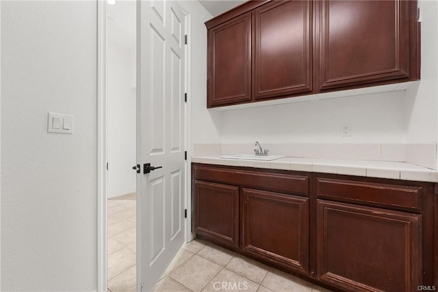 washroom featuring light tile patterned flooring and a sink