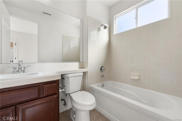 full bathroom featuring visible vents, vanity, toilet, and shower / bathtub combination