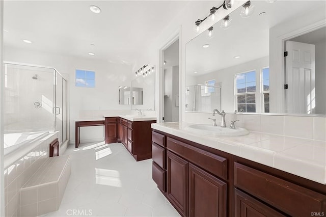 bathroom with a sink, two vanities, a stall shower, and a bath