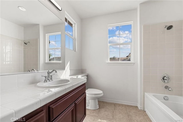 full bathroom featuring vanity, toilet, shower / bathtub combination, and a wealth of natural light