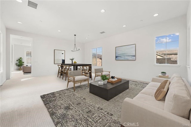 living area with recessed lighting, visible vents, carpet floors, and baseboards