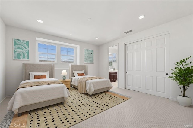 bedroom with recessed lighting, visible vents, light colored carpet, and a closet