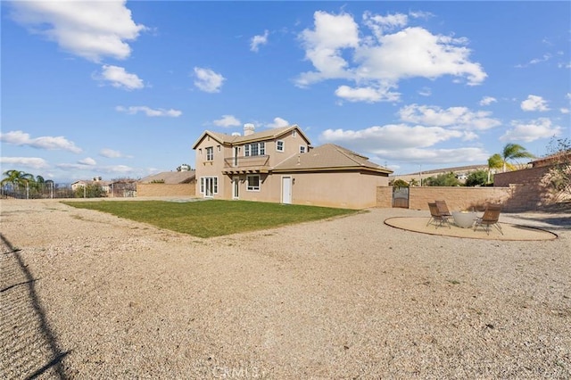 back of house featuring a patio area, a yard, and fence