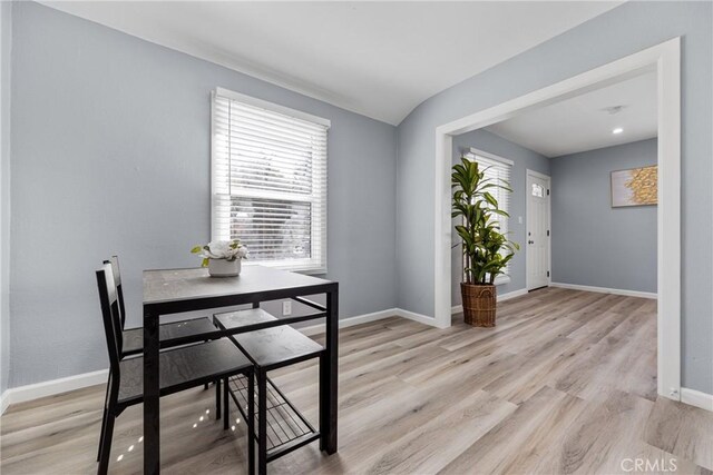 dining room with baseboards and light wood finished floors