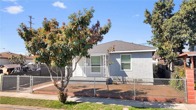 view of front of home featuring a fenced front yard, stucco siding, roof with shingles, and a gate