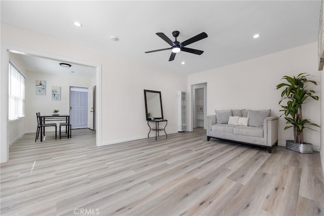 sitting room featuring recessed lighting, light wood-style flooring, a ceiling fan, and baseboards