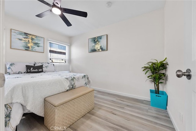 bedroom with baseboards, a ceiling fan, and light wood finished floors