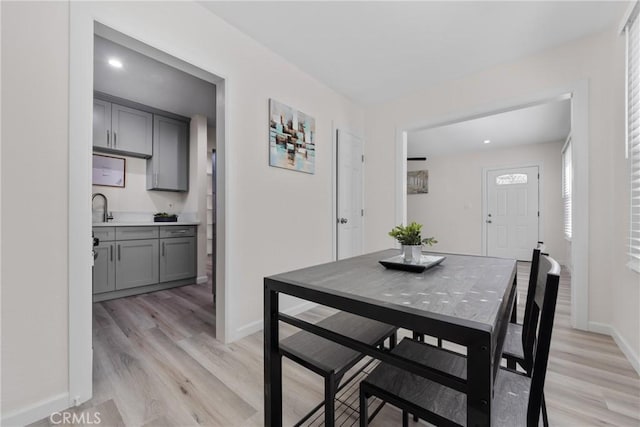 dining room with light wood-style flooring and baseboards