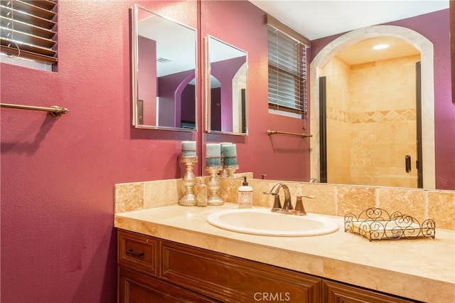 full bathroom with a shower stall and vanity