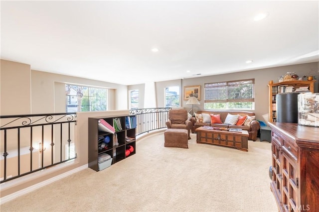 carpeted living area featuring recessed lighting and plenty of natural light