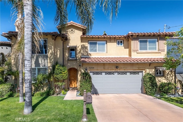 mediterranean / spanish-style home featuring driveway, an attached garage, stucco siding, a front lawn, and a tile roof