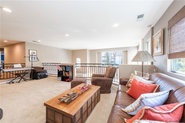 carpeted living area with recessed lighting and visible vents