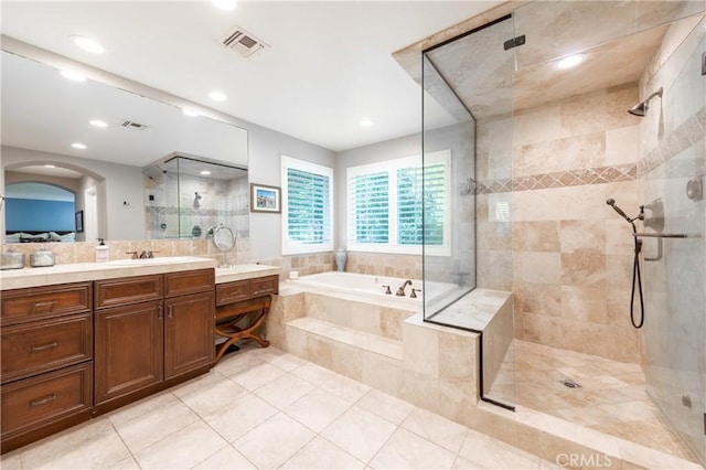 bathroom featuring a bath, visible vents, a shower stall, and vanity